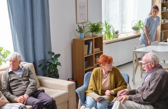 Elderly couple sitting in some chairs next to each other