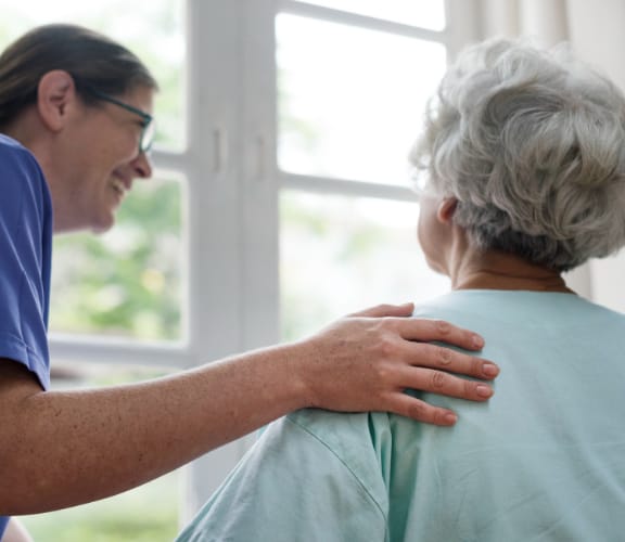 Woman with gray hair looking out a window